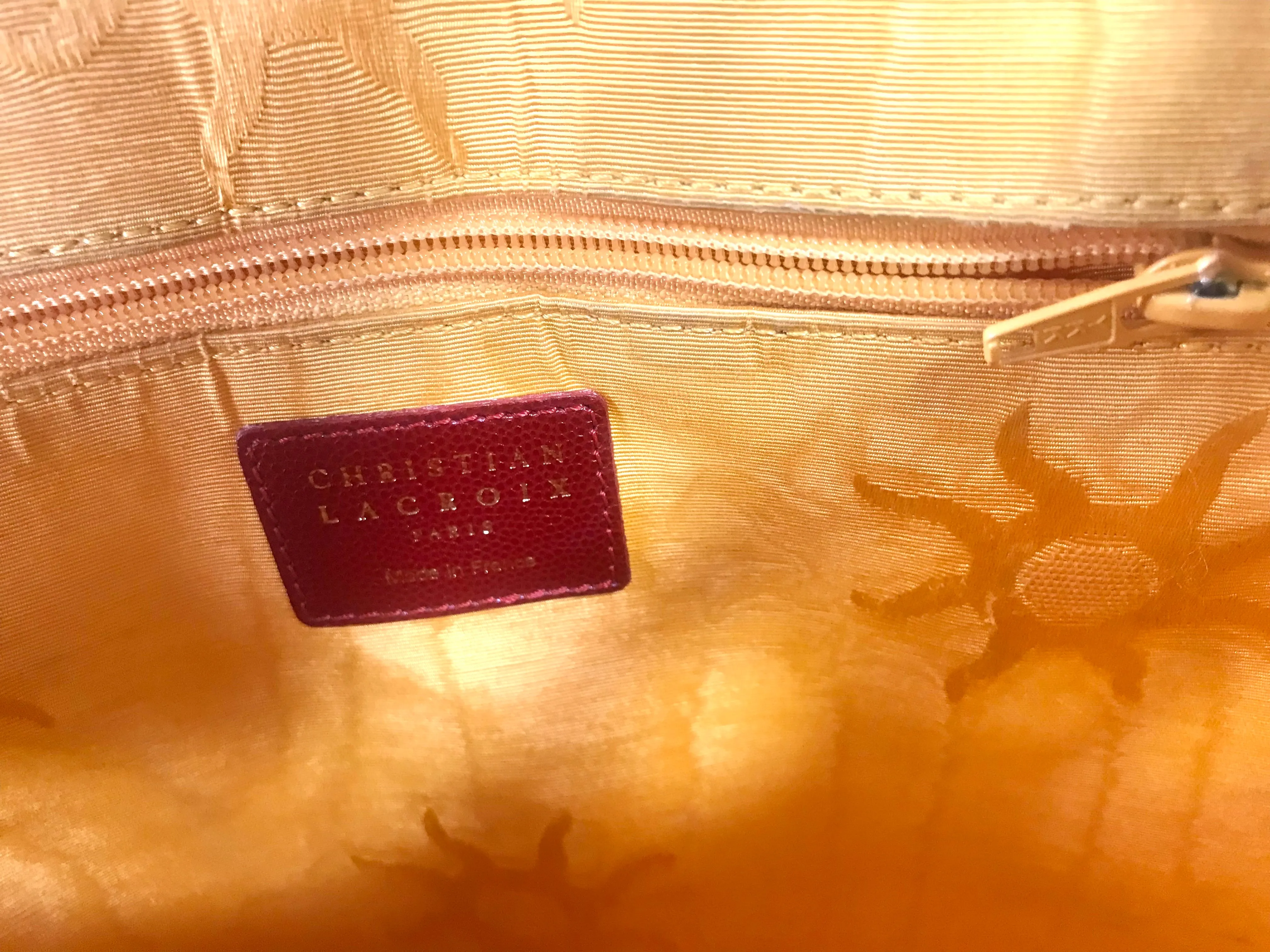 Vintage Christian Lacroix red patent enamel and leather bolide bag with golden logo zipper charm. Comes with shoulder strap. 0403172